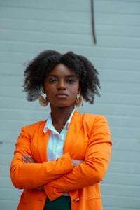 woman in orange blazer standing