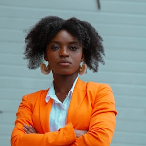 woman in orange blazer standing
