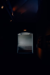 A bright, accessible area of refuge signaled within a hallway.