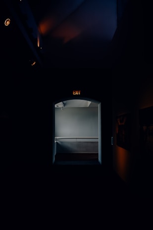 A bright hallway with night lights and clear pathways, designed to prevent falls for seniors at home.