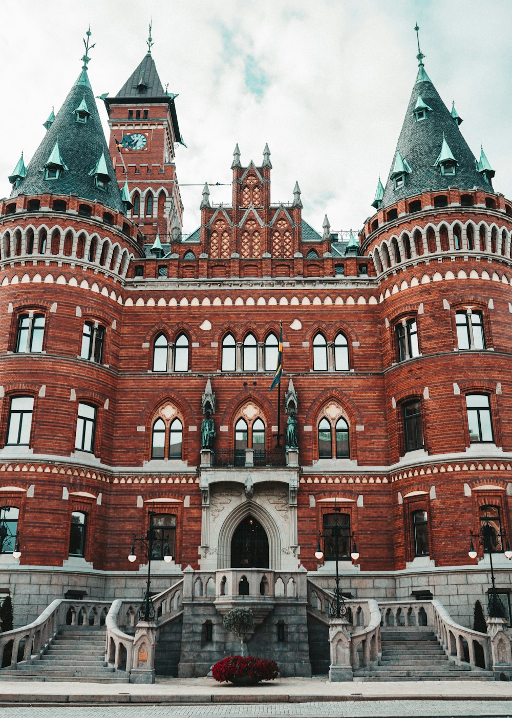 a large red brick building with a clock tower