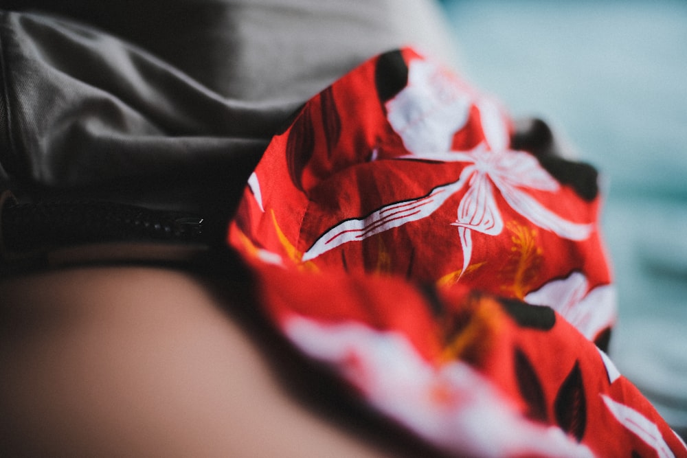 close-up photo of red and white floral texitle