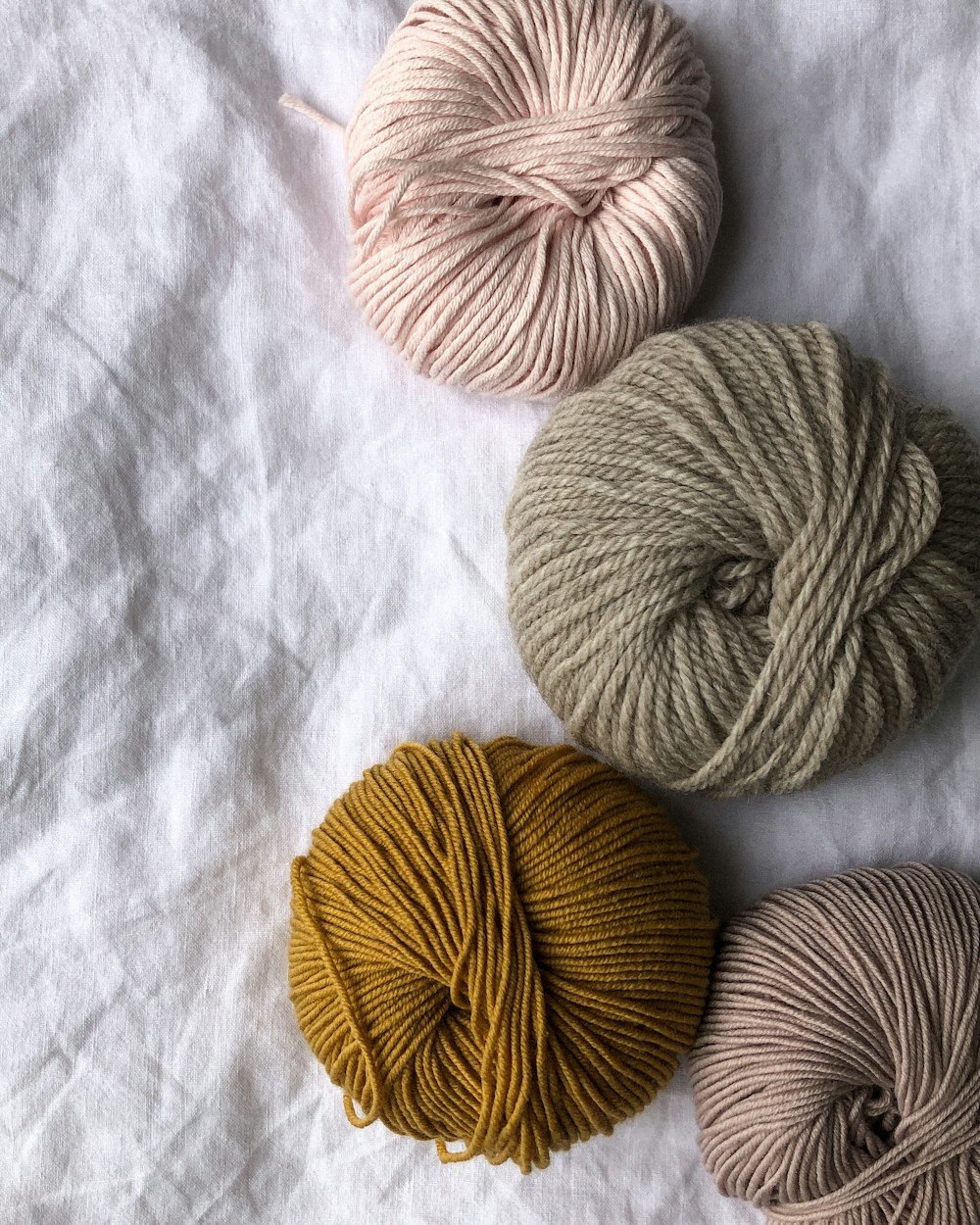 four assorted-color ball of yarns