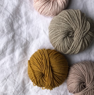 four assorted-color ball of yarns