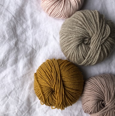 four assorted-color ball of yarns