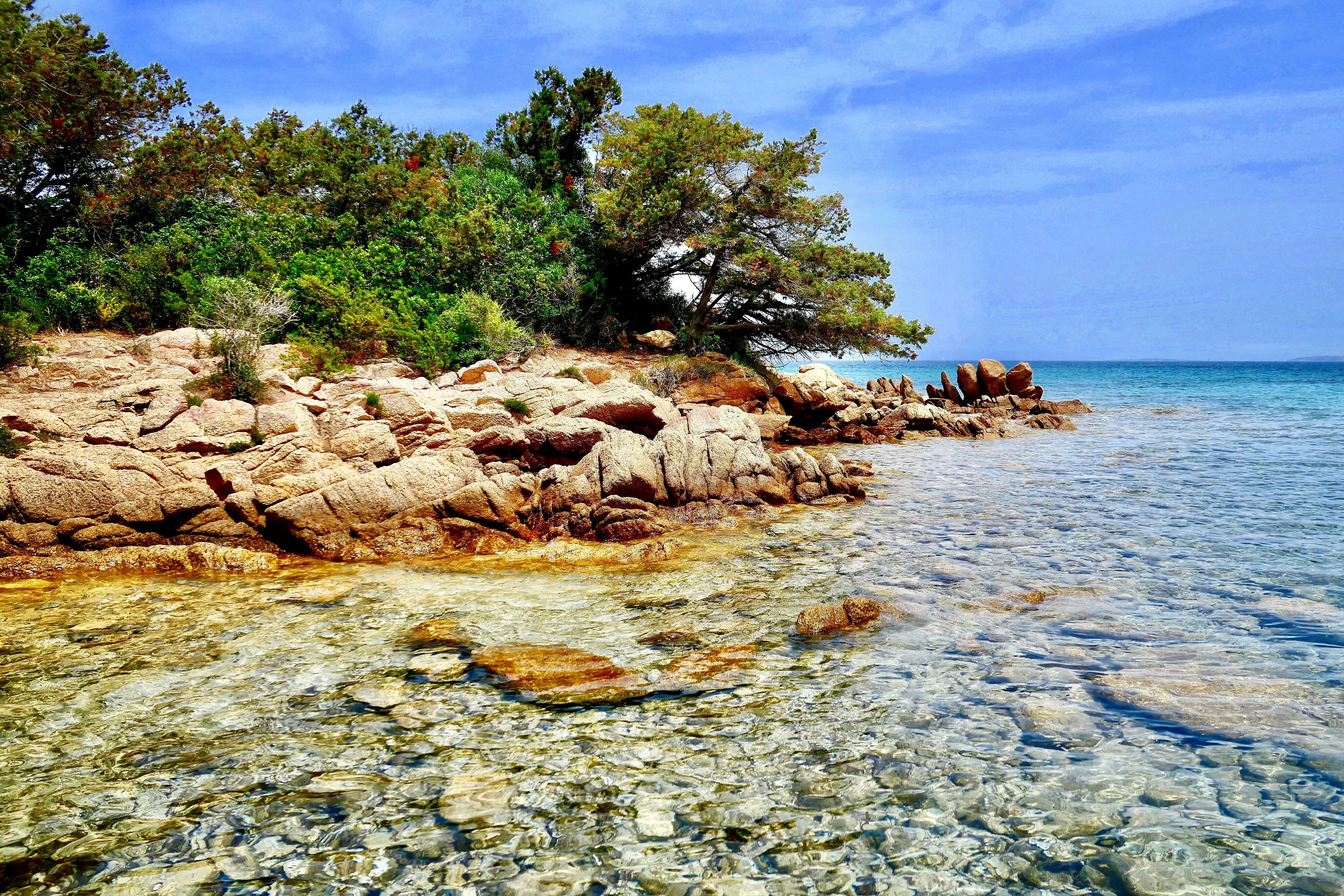 rocks by the body of water, Li Piscini beach 