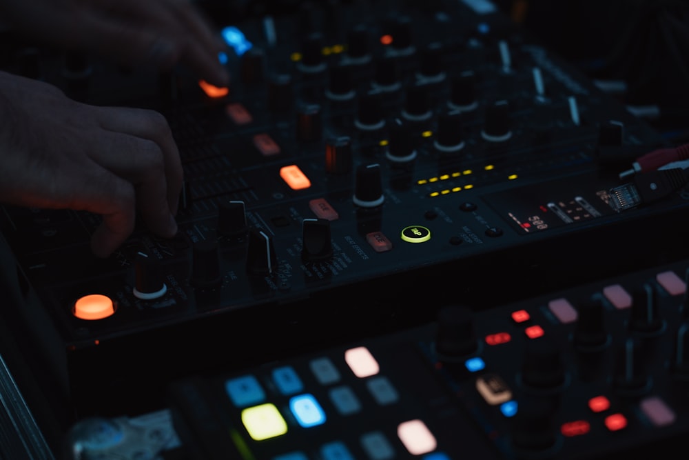 a dj mixing a track in a dark room