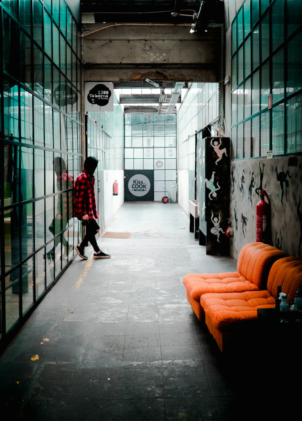 person standing near tufted orange sofa