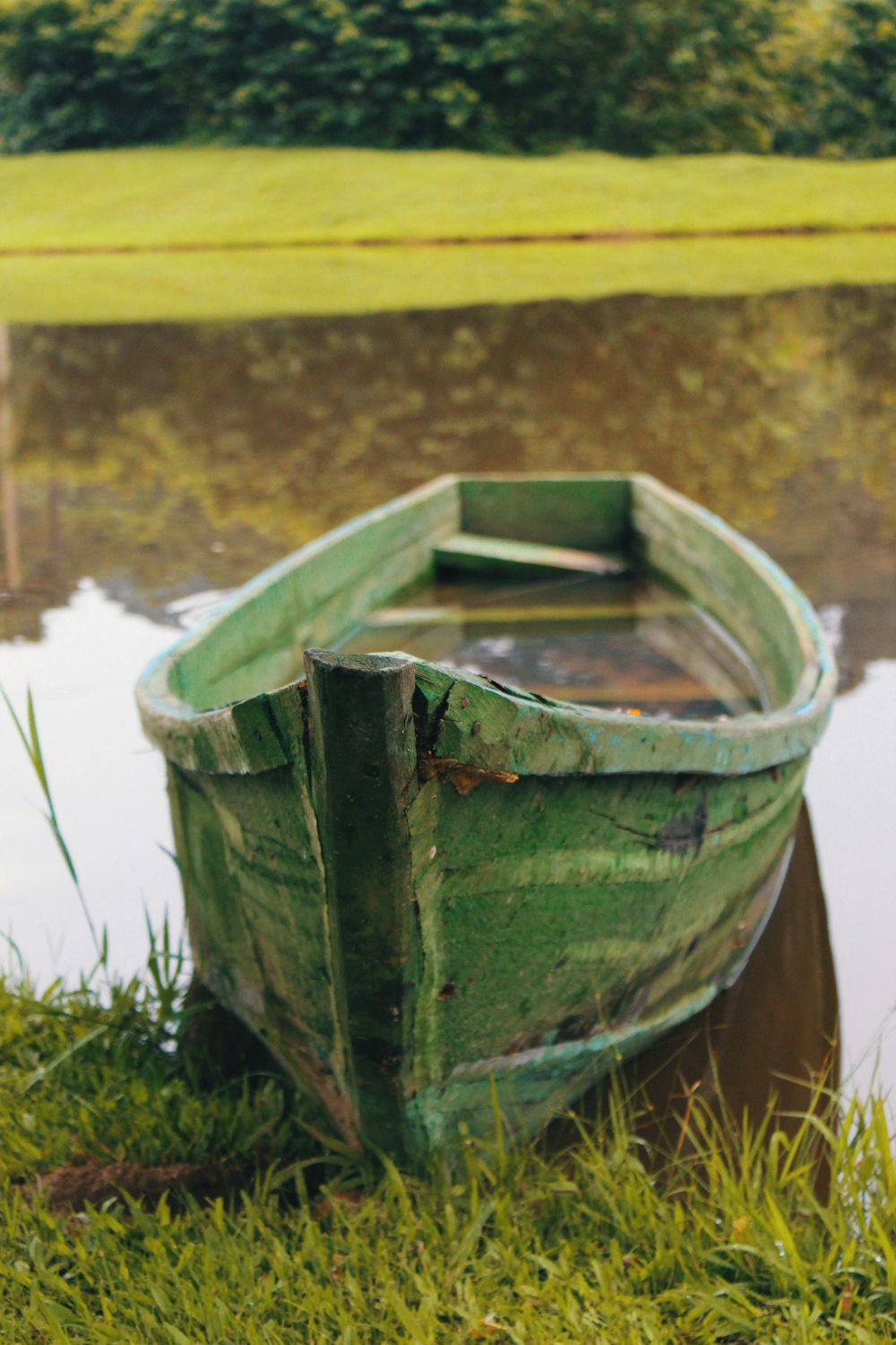 green boat on body of water