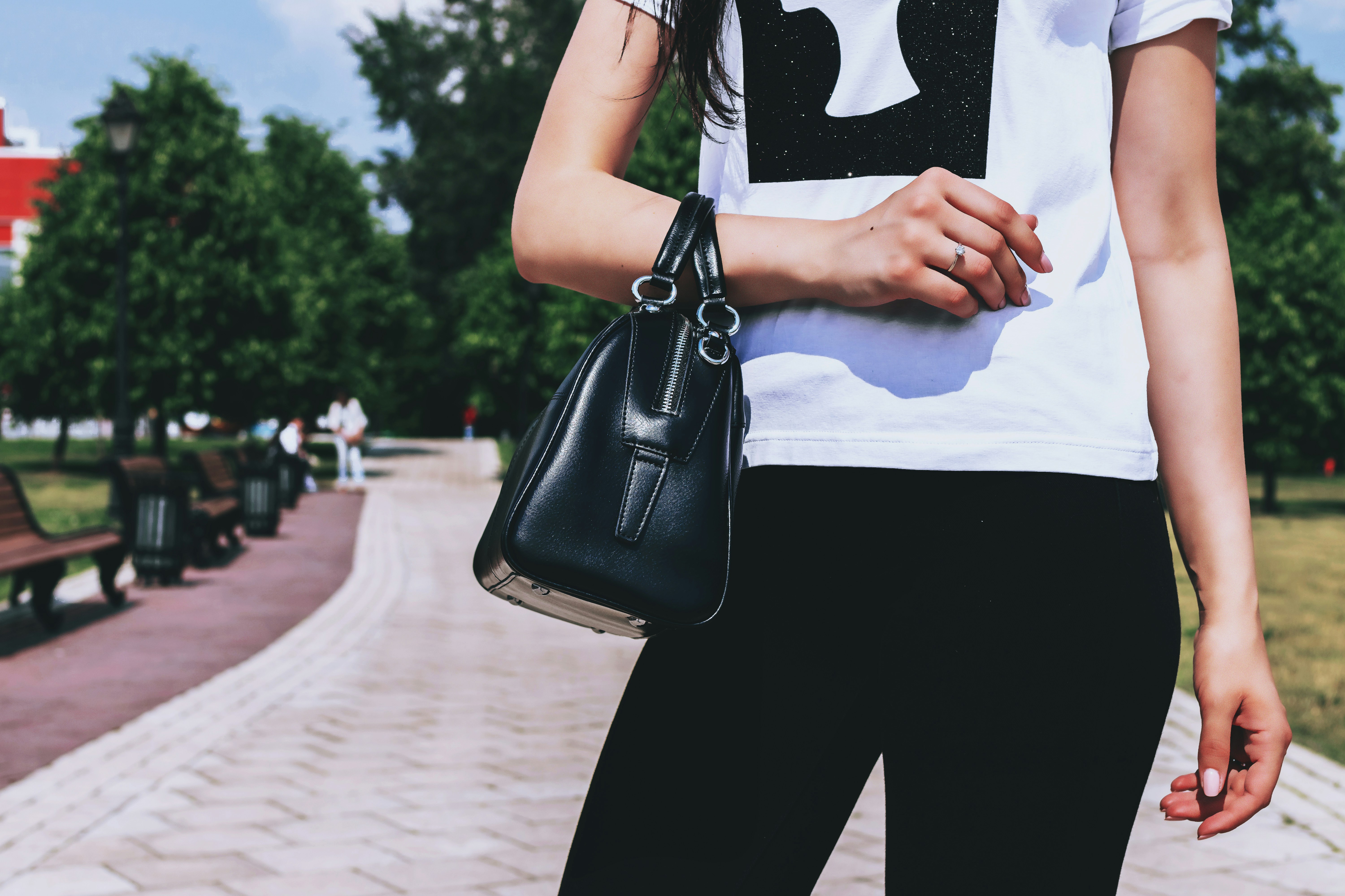 woman wearing white and black t-shirt and black pants, 