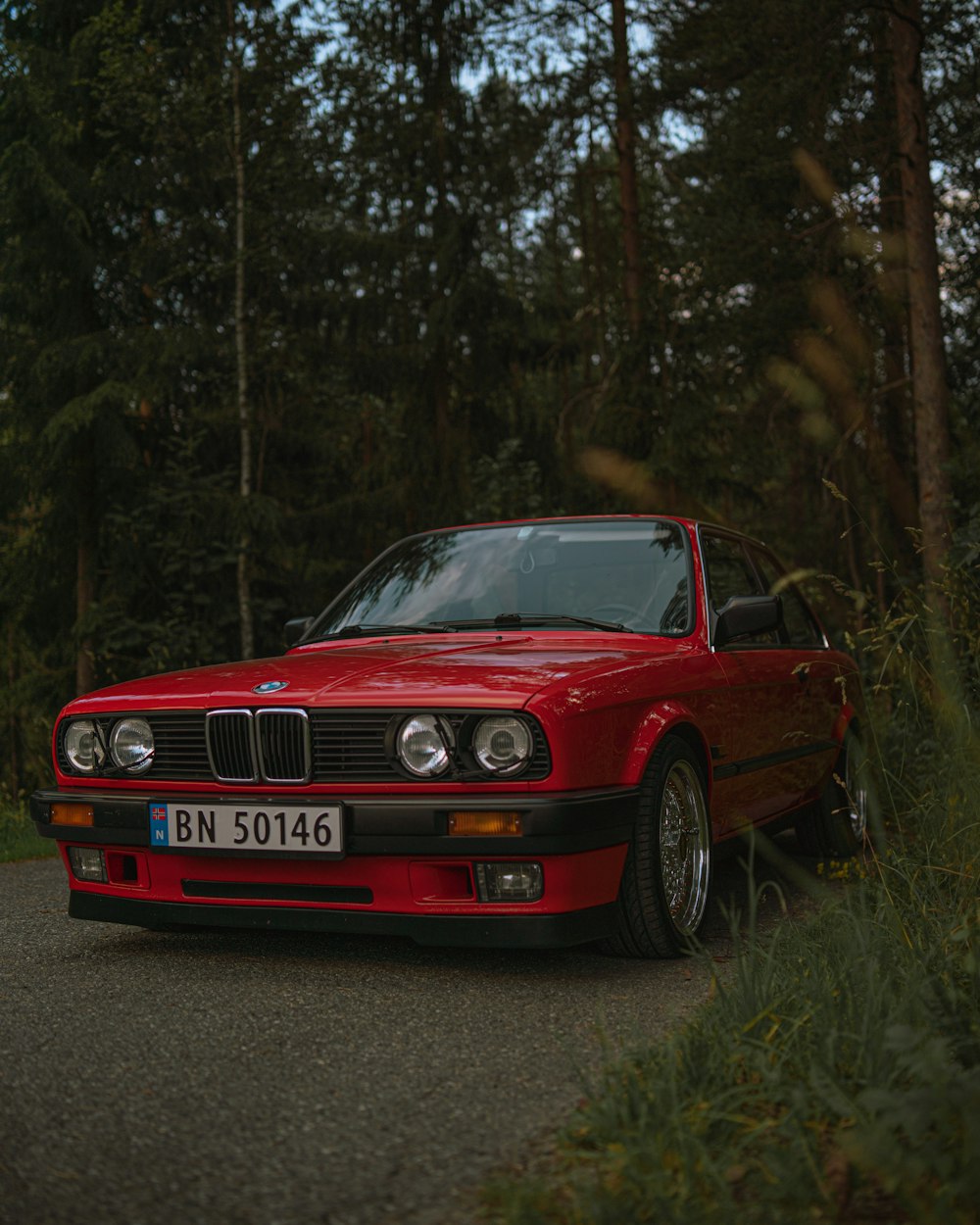 red BMW car parked on street