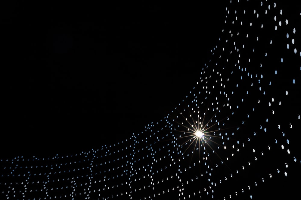 a black background with white dots and a star