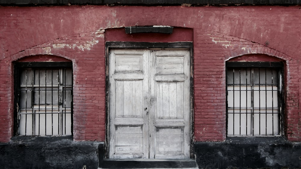 a red brick building with two white doors