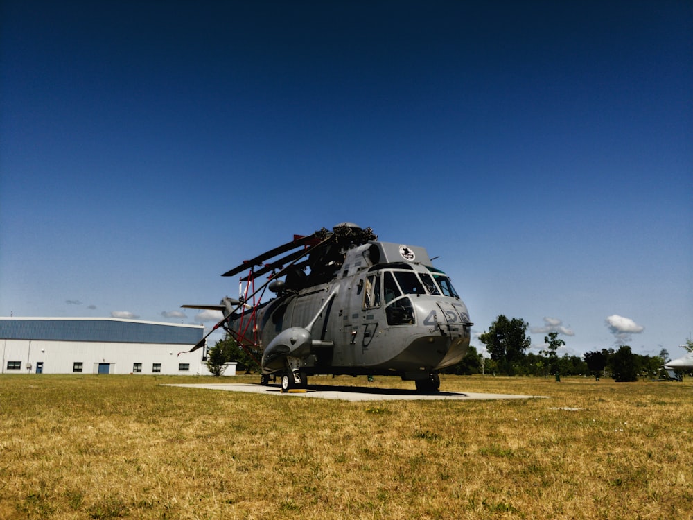 grey helicopter near white concrete building