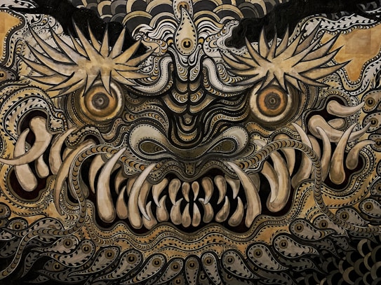 An intricate and detailed abstract depiction featuring swirling patterns and elaborate designs. The image conveys a mythical or fantastical creature with large, expressive eyes and prominent teeth, surrounded by ornate swirls and spiky shapes.