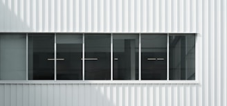 Exterior of a renovated commercial building in Wallan, featuring clean lines and a fresh coat of deep green paint.