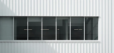 Exterior view of a renovated commercial building with fresh paint and new windows.