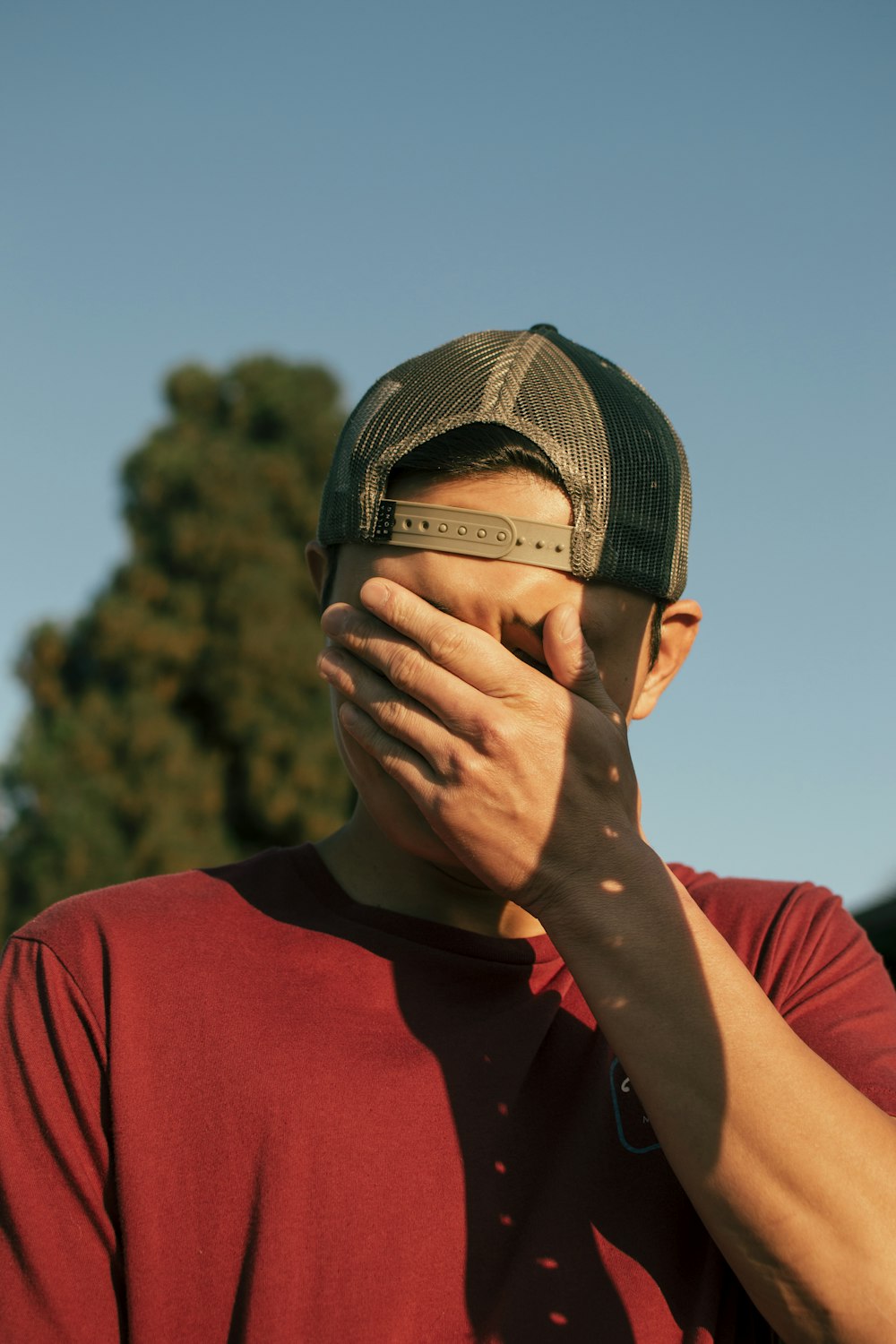 man covering his face