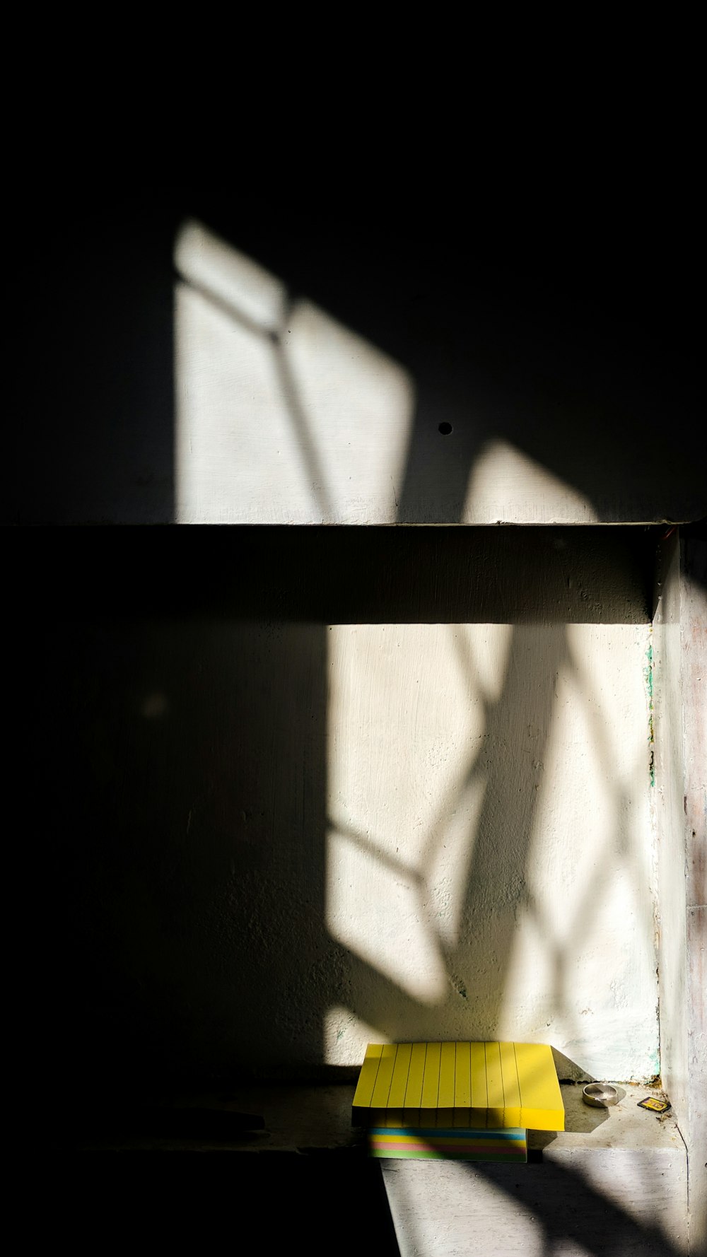 a yellow bench sitting in the middle of a room