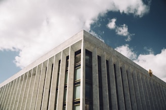A panoramic view of an institutional building with visible structural elements and modern design.
