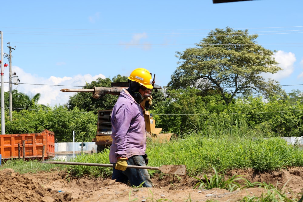 man carrying jack hammer