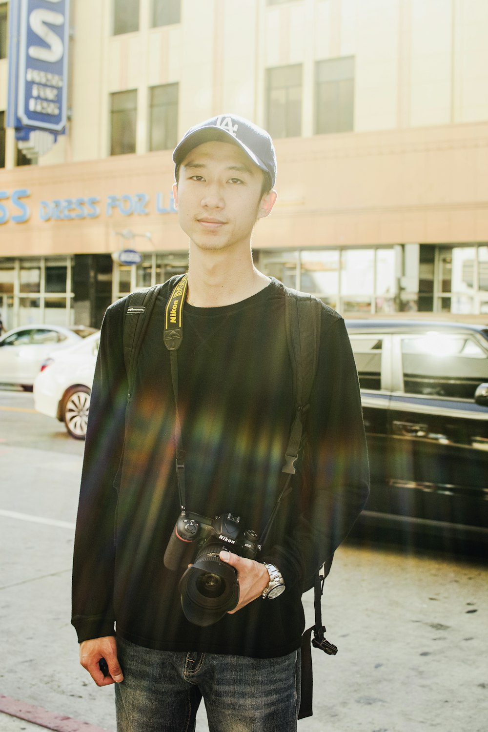 man standing with black DSLR camera