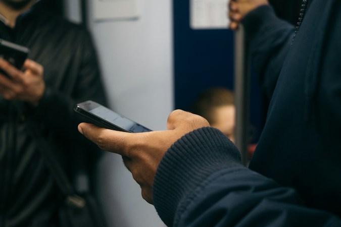 A person checking a smartphone before heading out, the recommended step before a home game