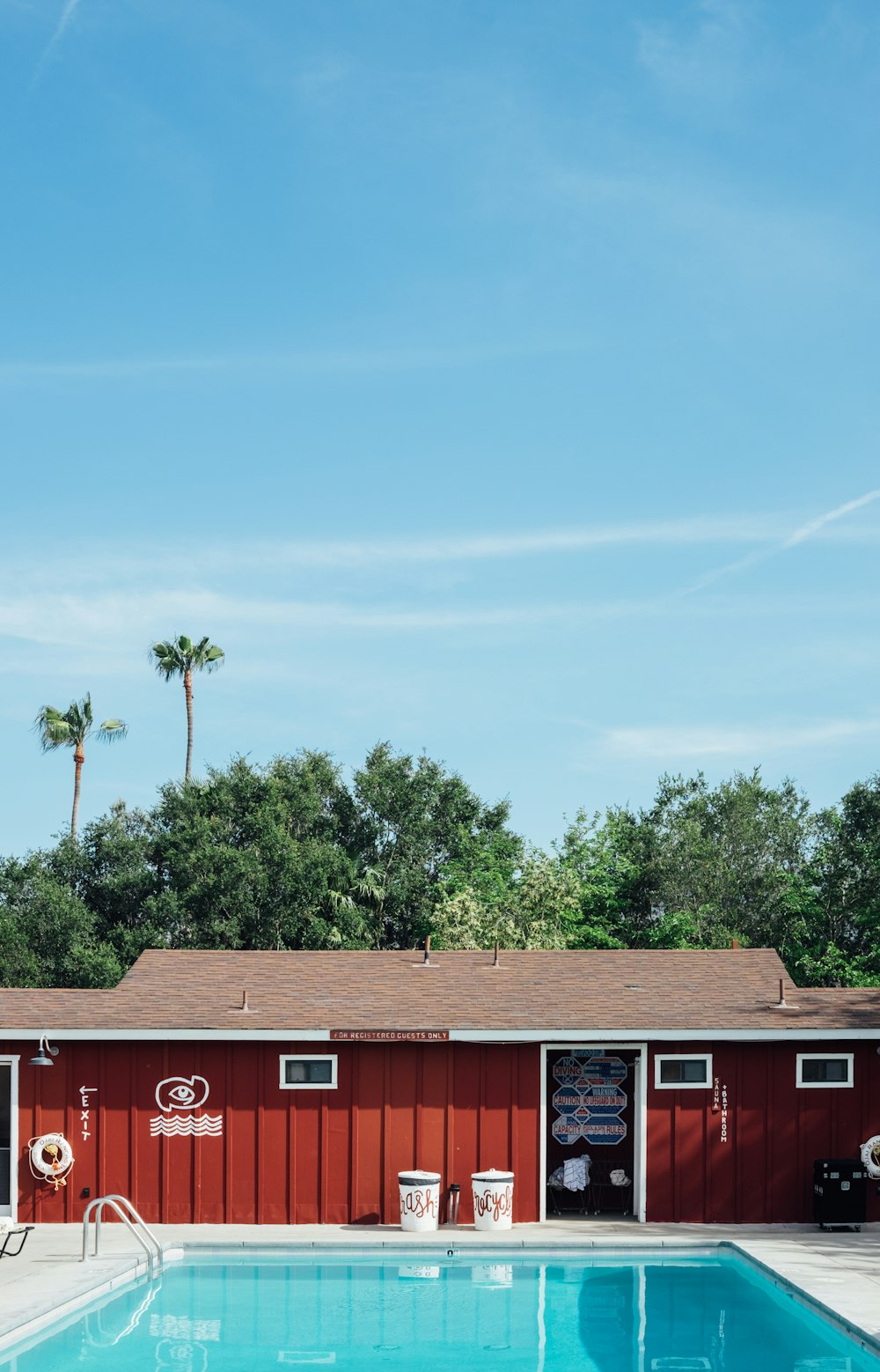 a red building with a pool in front of it