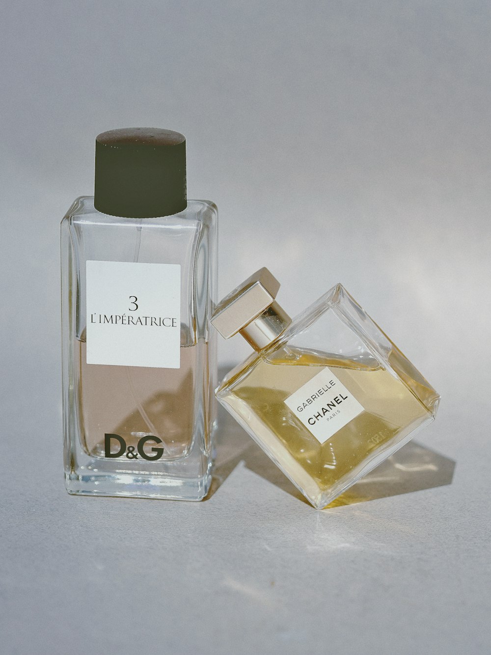 two assorted-label fragrance bottles