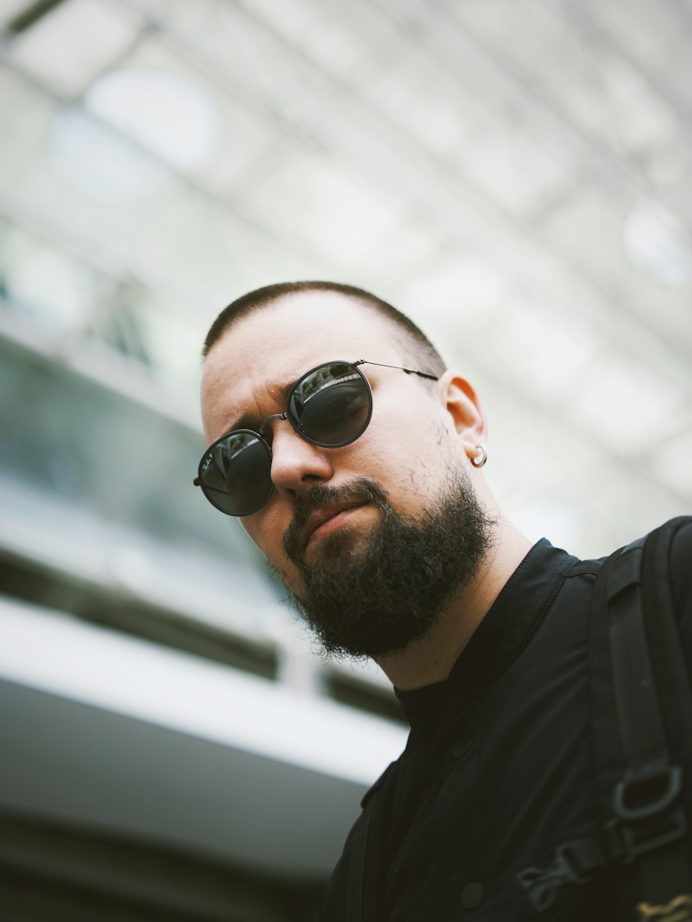 a man with a beard wearing sunglasses and a backpack