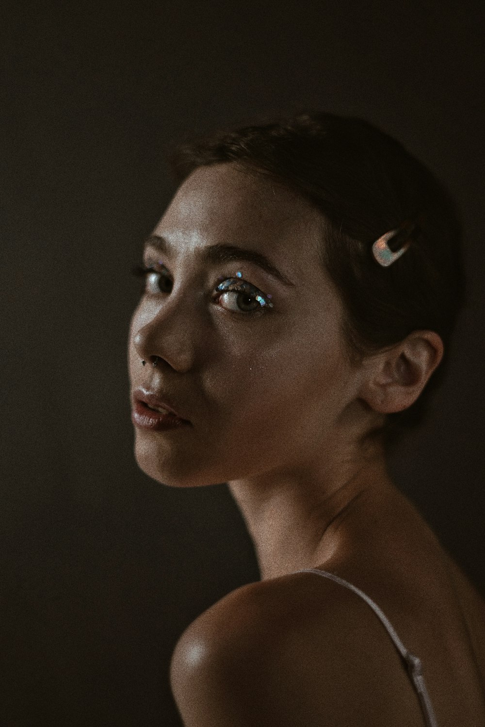 a woman with blue eyes and a white top