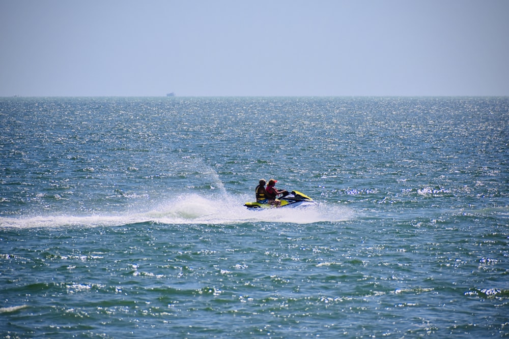 person riding personal watercraft during daytime