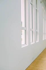 Minimalist art studio with bright natural light and sleek white walls.