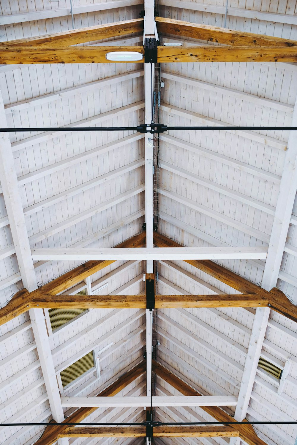 the ceiling of a building with wooden beams