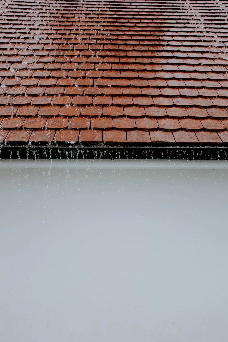 Rainwater running across roof tiles