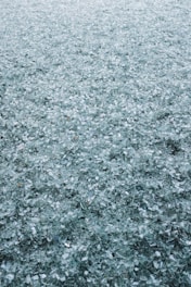 Reflective glass beads scattered on a road surface enhancing visibility.