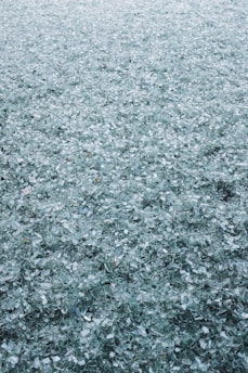 Reflective glass beads scattered on a road surface enhancing visibility.