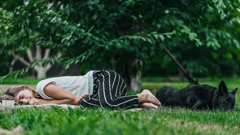 woman lying on grass field
