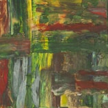 A vibrant hand-painted canvas showing an abstract landscape with warm tones.