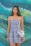 woman wearing blue and white floral spaghetti-strap dress