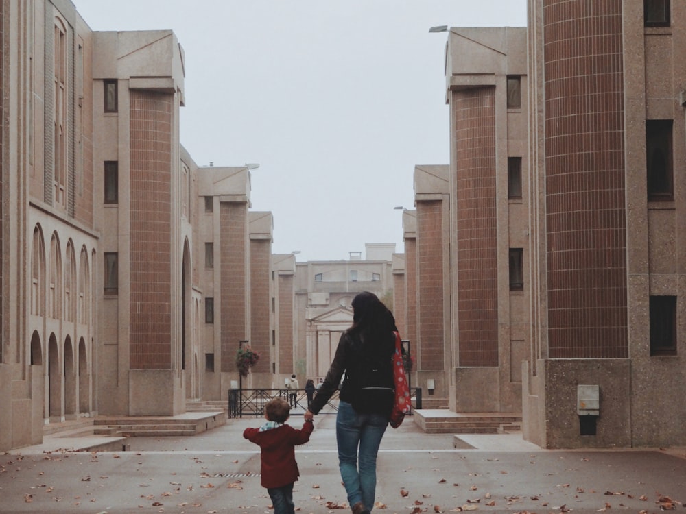 a woman and a child walking down a street