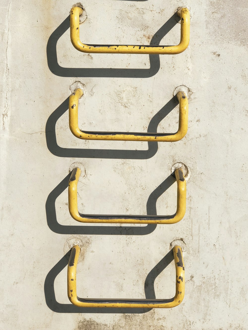 four yellow metal grab bars