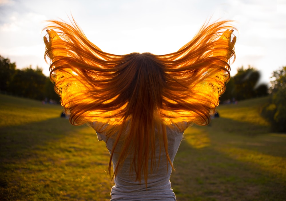 woman standing and waving her hair