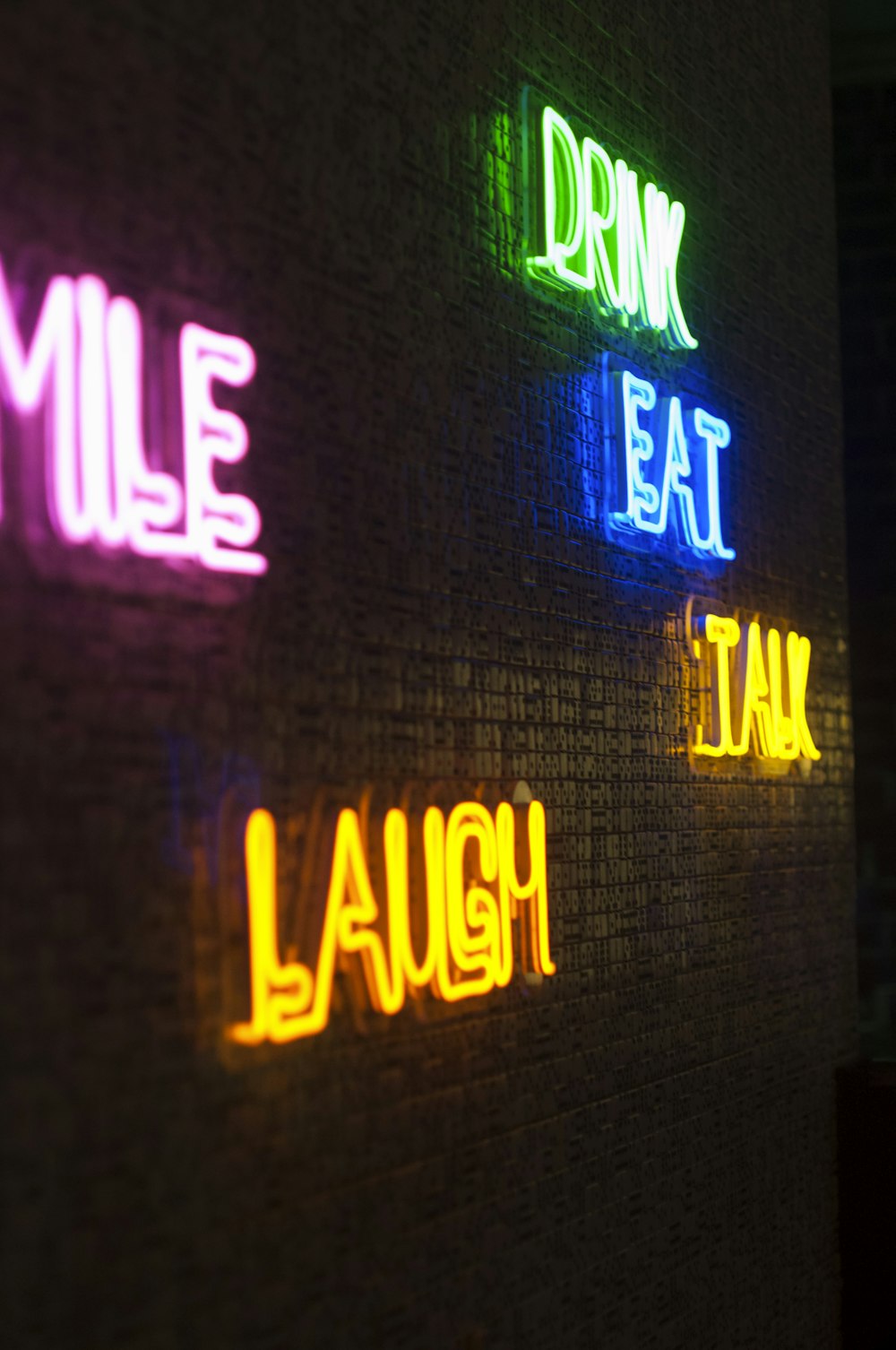 neon light signage on brick wall