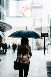 woman standing under umbrella