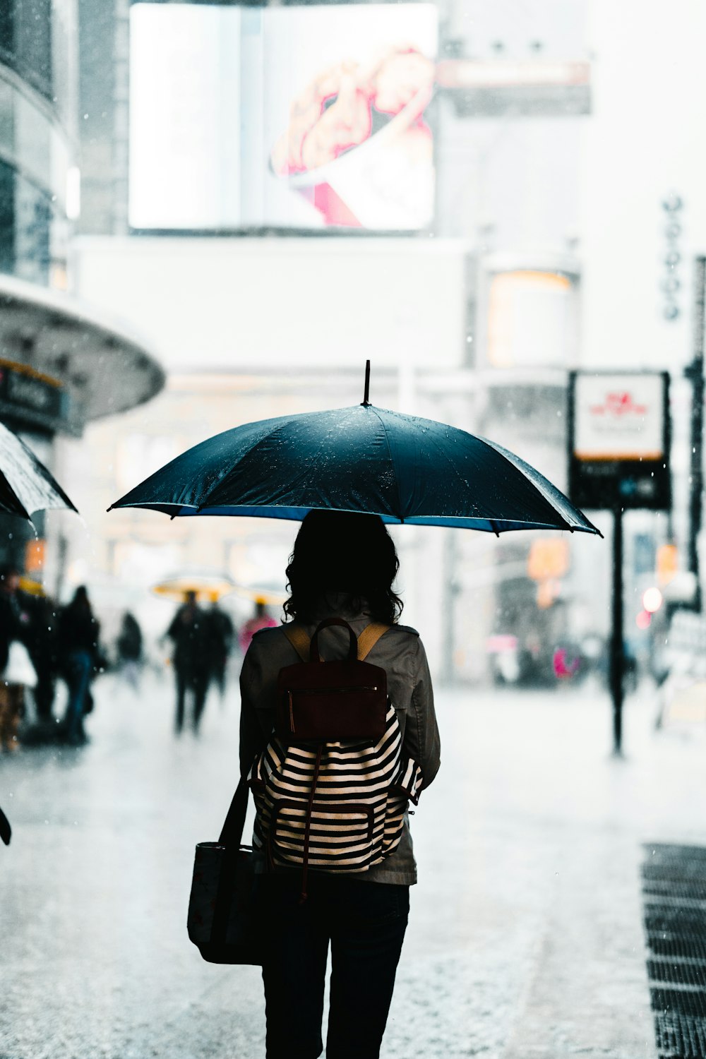 woman standing under umbrella