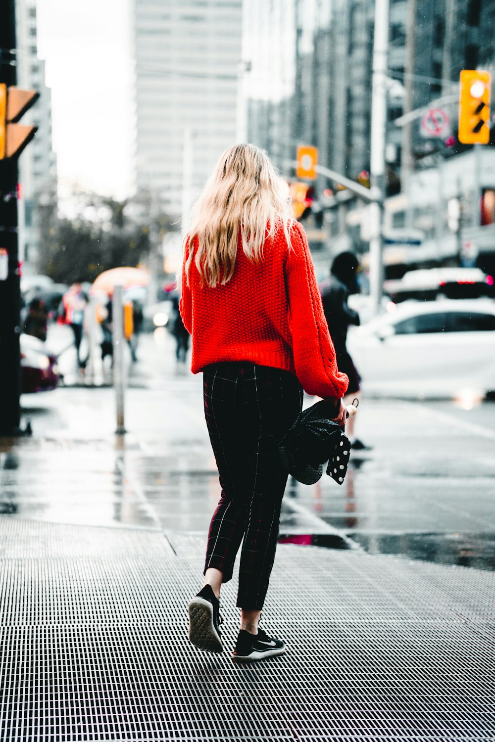 woman wearing red sweater and black pants