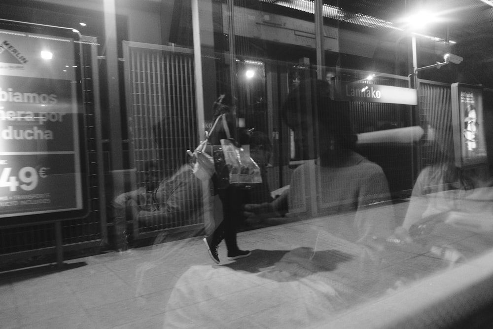 grayscale photography of woman walking