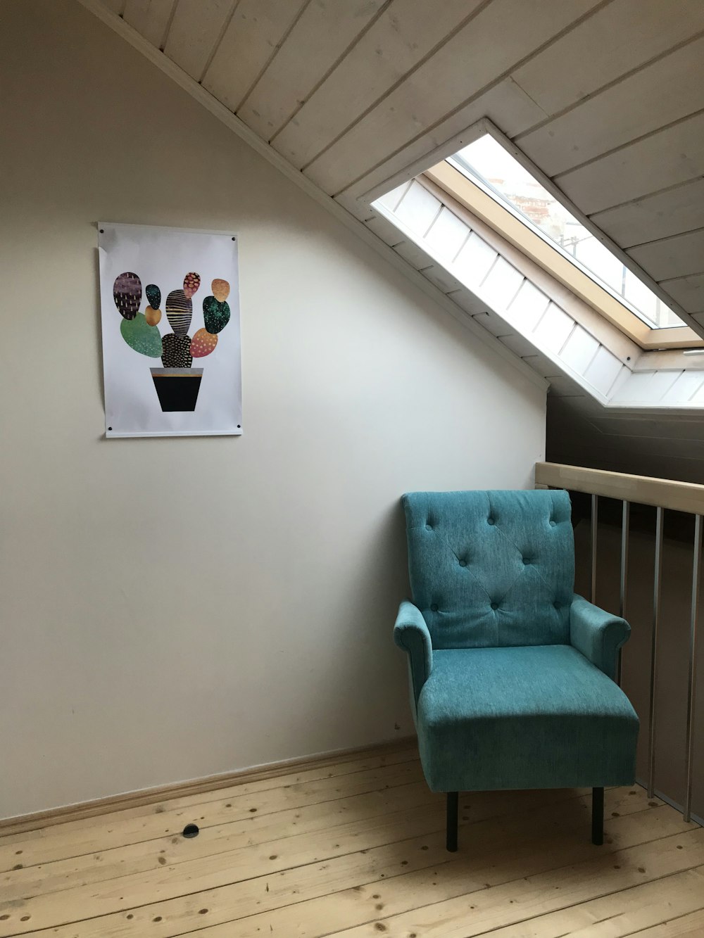 blue fabric sofa chair near window