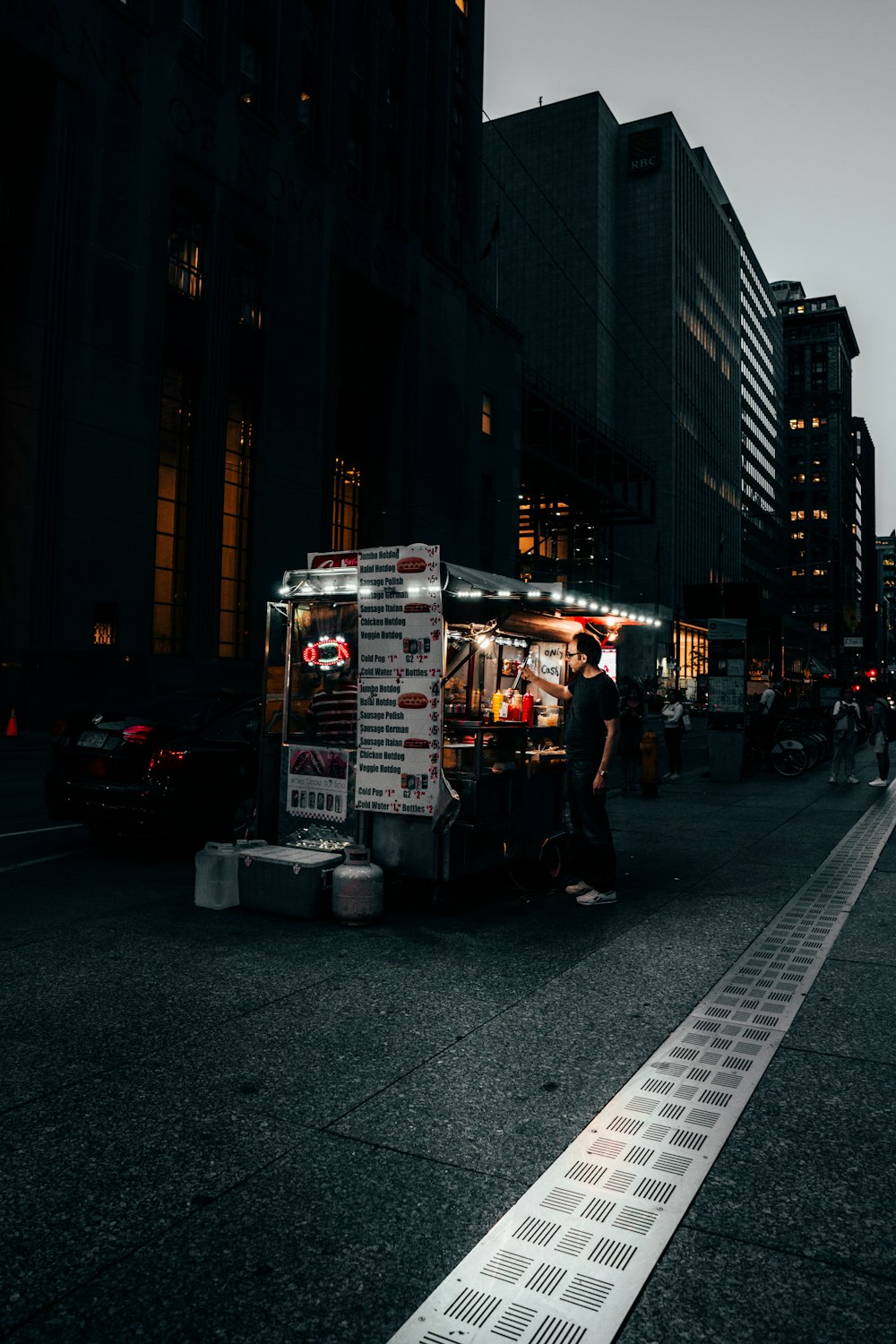 man standing beside food stall